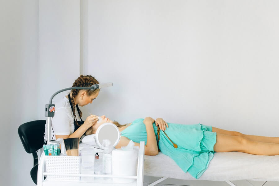 a lash technician working on a client